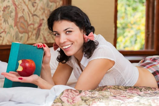 Woman show half bitten apple and brightly smile