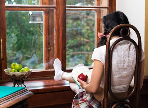 Woman on wooden chair look out of window