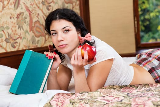 Pretty woman hold bitten apple and look questionable