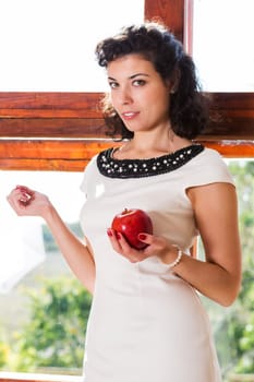 Woman on sill smile and posing with apple