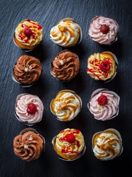 Variation of different cupcakes on black background