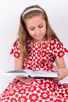 Cute schoolgirl reading book
