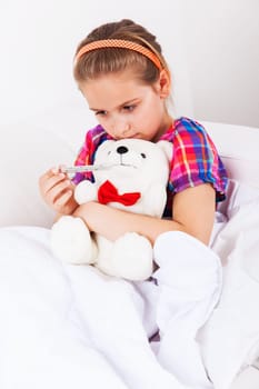 Cute girl doctor with teddy bear