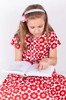 Cute schoolgirl reading book