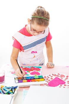 Schoolgirl painting with watercolor on white background
