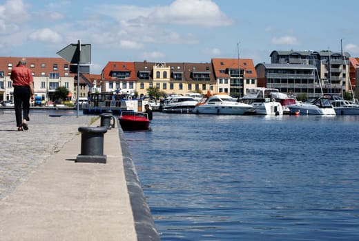 Waren,Mecklenburg Vorpommern/Germany – June 09,2013: A man sits on his motorboat in the marina of the city of Waren on June 9 in Waren.