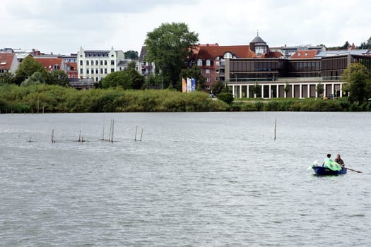 Schwerin,Germany – August 11,2013: A fisherman lays out pots on Lake Schwerin to catch fish on August 11,2013 in Schwerin.