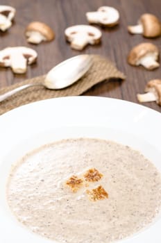Mushroom soup with mushrooms and croutons in portrait format
