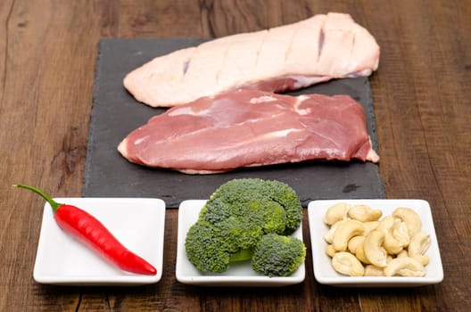 Raw duck breast and ingredients for a recipe