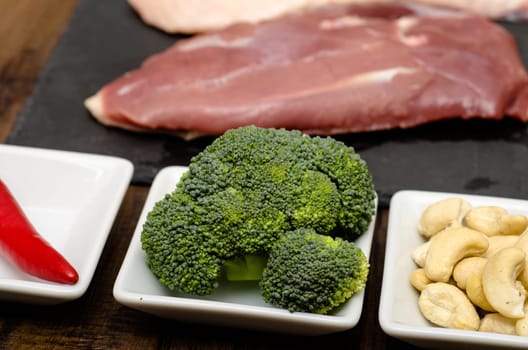 Broccoli and cashew kernels with raw duck breast