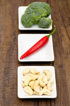 Cashew nuts,chili and broccoli as ingredients in portrait format