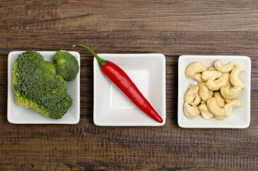 Broccoli,chili and cashew nuts in white shells