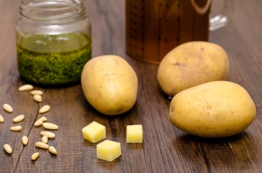 Raw potatoes with pesto and broth as ingredients