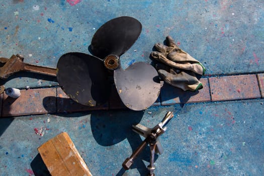 boat propeller improvement tools and gloves during a repair work