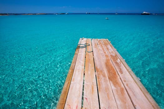 Formentera Ses Illetes beach pier Illetas with Ibiza background at balearic islands