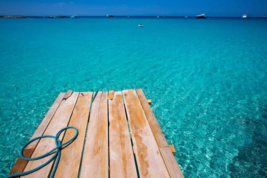 Formentera Ses Illetes beach pier Illetas with Ibiza background at balearic islands