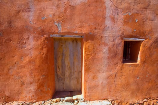 Ibiza grunge orange facade in Benirras beach at Balearic Islands Spain