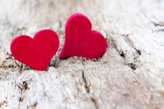 two red hearts on wooden background
