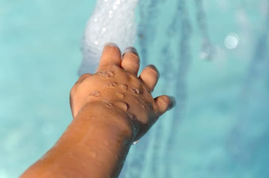 baby hand on a fountain
