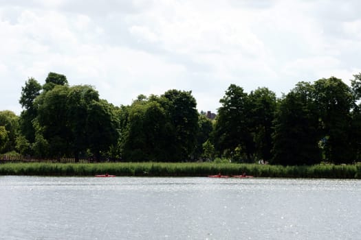 Three canoeists sail along the shores of Lake Schwerin.