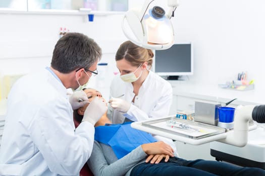 Experienced dentist in his practice