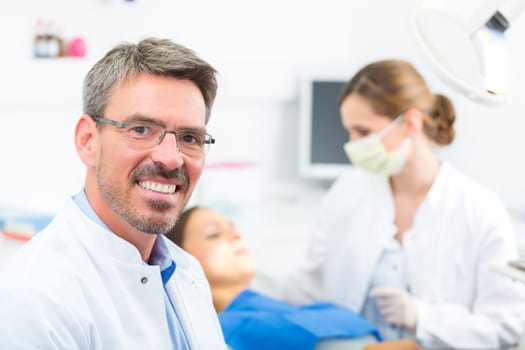 Experienced dentist in his practice