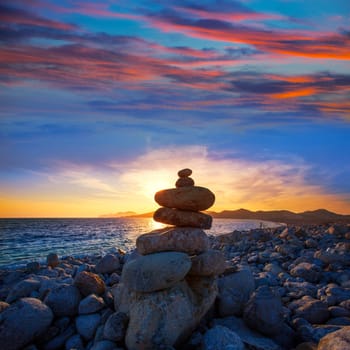 Ibiza Cap des Falco sunset with desire stones at the beach in Sant Josep Balearic Islands