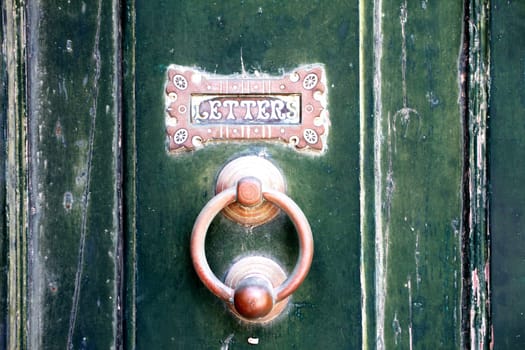 Old door with letterbox background.