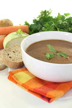 a white bowl with oxtail soup and parsley
