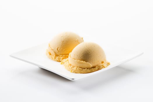 Vanilla ice cream scoops isolated on white