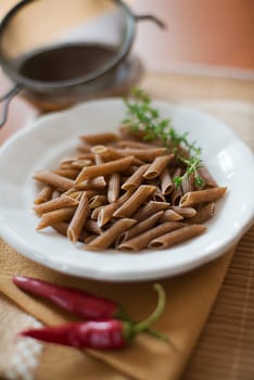Raw whole grain pasta close up shoot