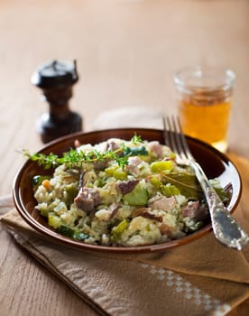 Risotto with mushrooms, meat and vegetables close up