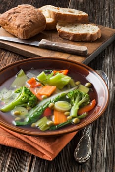Vegetable soup in brown plate close up