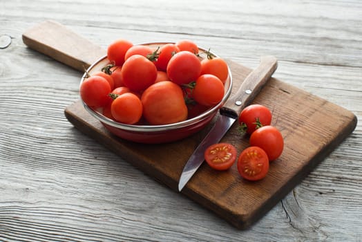 Fresh tomatoes on wooden board close up shoot