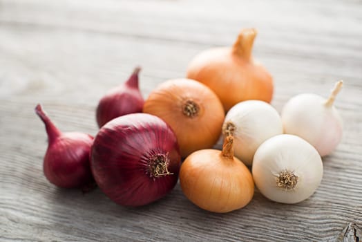Onions on wooden background close up shoot