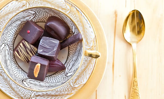 Various chocolates in vintage teacup