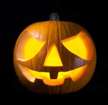 Scary old jack-o-lantern on black background close up