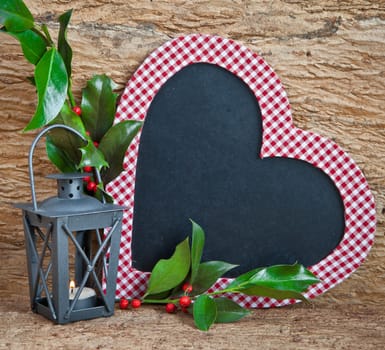 Heart-shaped table,small lantern with candle and holly branches