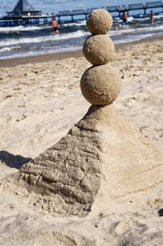 Sandcastle on the beach of Heringsdorf,in the background the pier - Island of Usedom