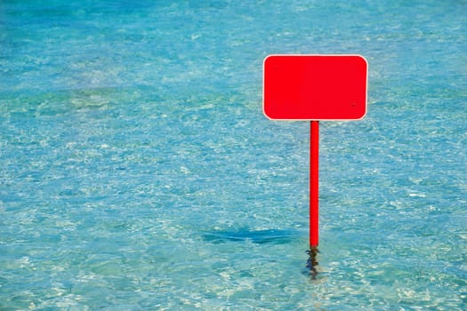 turquoise tropical sea with red sign blank copyspace