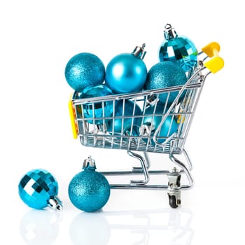 Shopping cart full of christmas balls isolated on white background