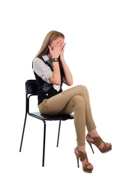 girl in a chair covering her face