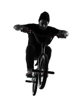 one caucasian man exercising bmx acrobatic figure in silhouette studio isolated on white background