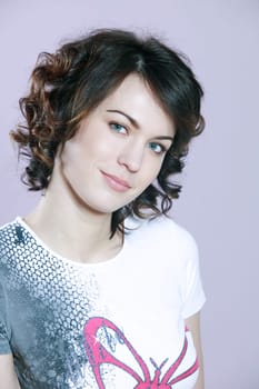 studio shots portrait of a beautiful caucasian young smiling woman on purple background