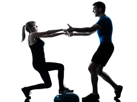 caucasian aerobics instructor  with mature woman exercising fitness workout in silhouette studio isolated on white background