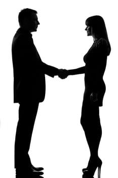 one caucasian couple man and woman handshake in studio silhouette isolated on white background