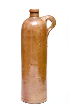 Old brown earthenware bottle in portrait format