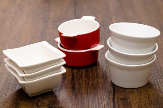 Stack different porcelain bowls on a table