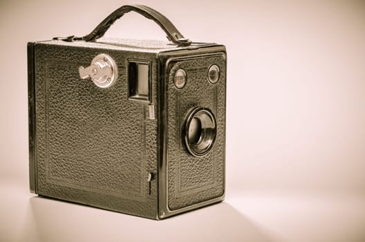 Old box camera in black and white with sepia toning