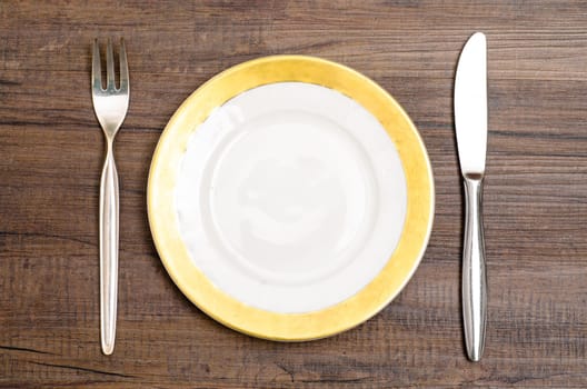 Silver cables and knives with plate on a dining table
